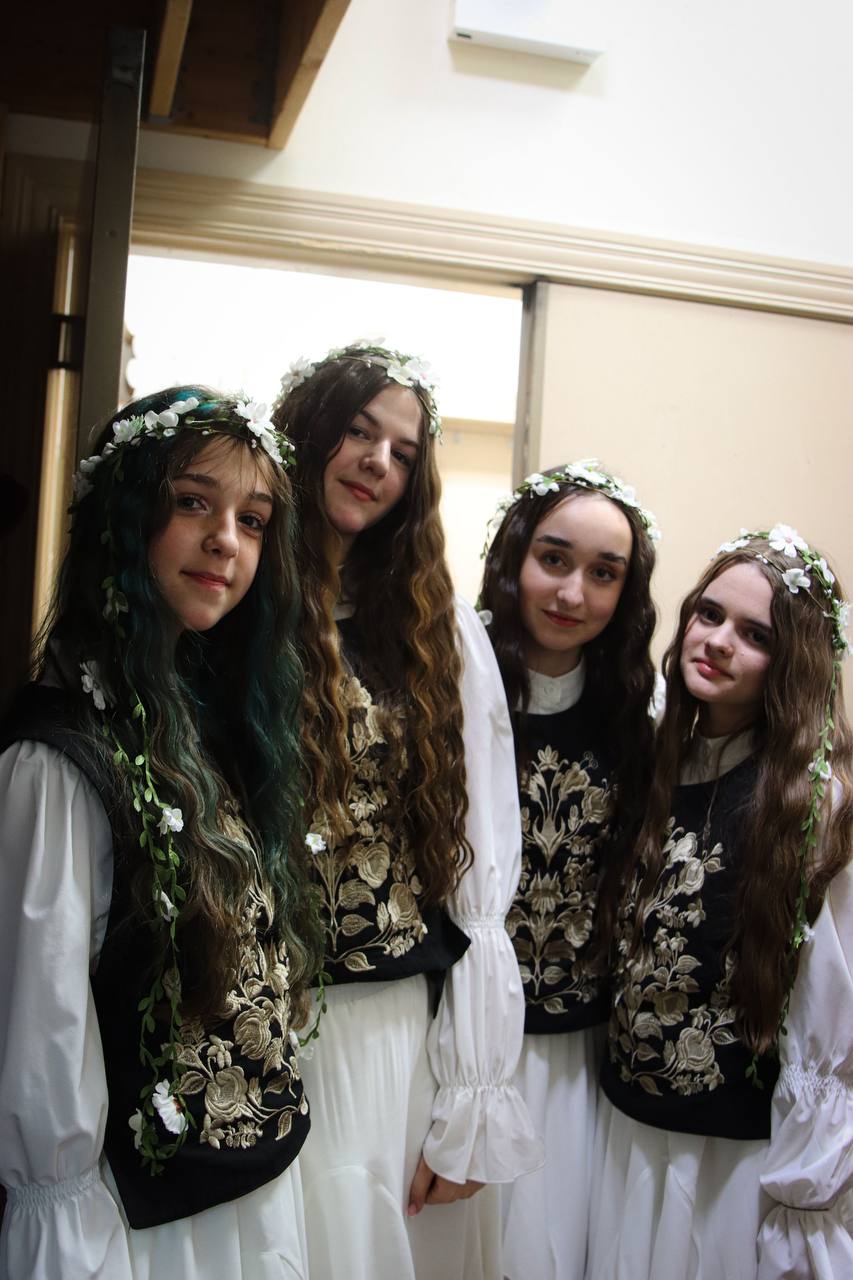 Young singers in traditional embroidered costumes with flower crowns